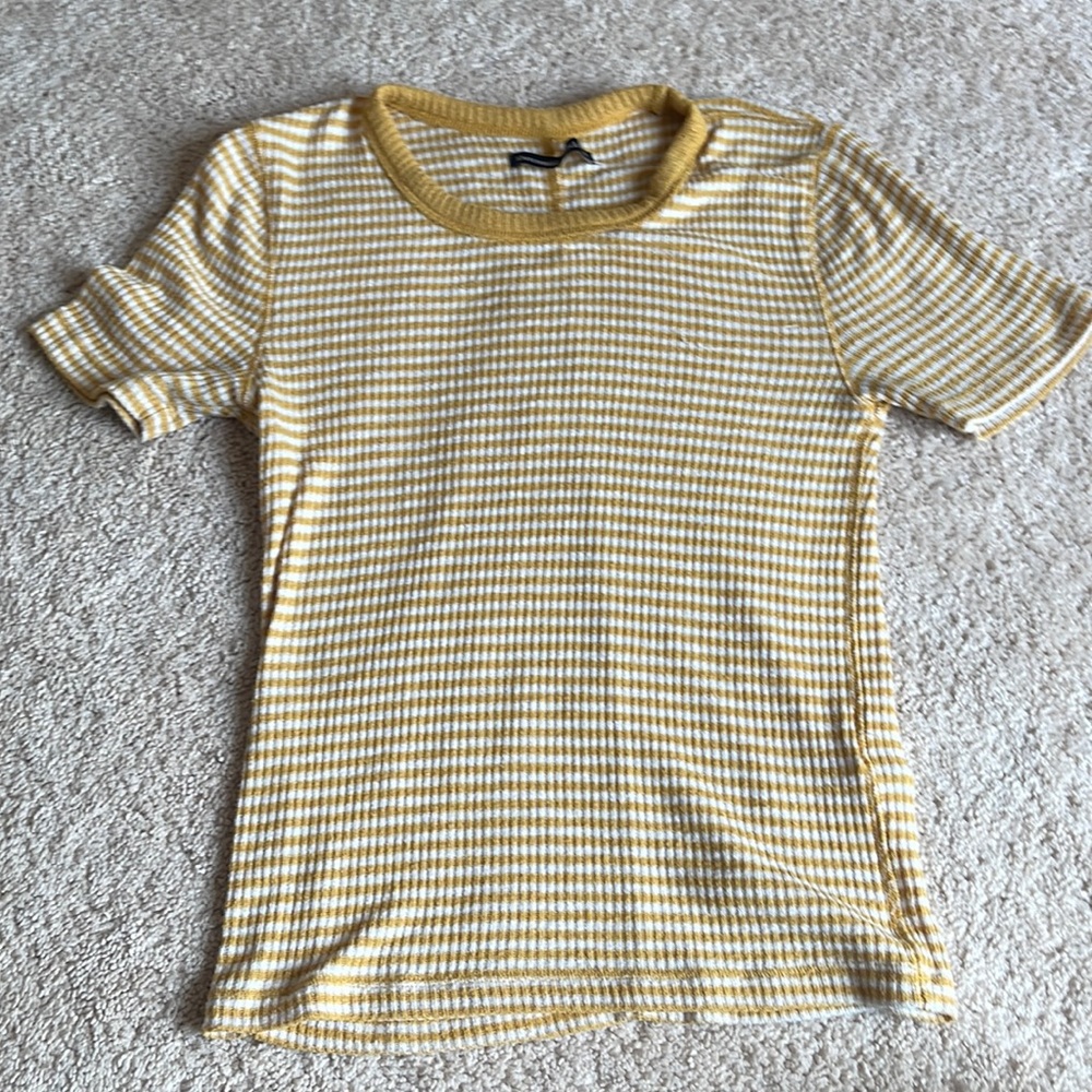 A yellow top with stopped horizontal lines. Shirt can be worn anywhere casually